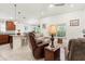 Cozy living room featuring tile flooring, comfortable seating, and an open layout to the kitchen at 4466 Manila Ave, North Port, FL 34288