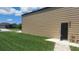 Side view of an outbuilding on a grass lot with an entry door and a clear driveway at 4466 Manila Ave, North Port, FL 34288