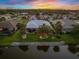 Aerial view showcasing the backyard, waterfront lot, and tranquil neighborhood setting at 490 Pine Lily Way, Venice, FL 34293