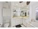 Bathroom featuring double vanity, garden tub, and lots of natural light at 490 Pine Lily Way, Venice, FL 34293