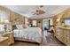 Main bedroom features wood-look floors, ceiling fan, and access to the pool at 490 Pine Lily Way, Venice, FL 34293