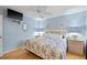 Cozy bedroom with blue walls, ceiling fan, and comfortable bed at 490 Pine Lily Way, Venice, FL 34293