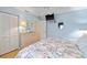 Bright blue bedroom with closet, ceiling fan, and mounted TV at 490 Pine Lily Way, Venice, FL 34293
