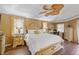 Spacious bedroom with decorative ceiling fan, wood-look flooring, and natural light at 490 Pine Lily Way, Venice, FL 34293