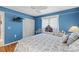 Bright blue bedroom with closet, ceiling fan, and comfortable seating at 490 Pine Lily Way, Venice, FL 34293