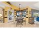 Cozy breakfast nook features a decorative light fixture and views to the pool at 490 Pine Lily Way, Venice, FL 34293