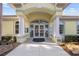 Inviting clubhouse entrance with classic architectural details, perfect for community gatherings at 490 Pine Lily Way, Venice, FL 34293