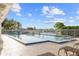 Community pool featuring a spacious sun deck and relaxing lounge chairs under clear skies at 490 Pine Lily Way, Venice, FL 34293