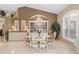 Formal dining room with elegant chandelier, display cabinet, and plenty of natural light at 490 Pine Lily Way, Venice, FL 34293