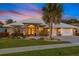 Charming single-Gathering home with a well-manicured lawn, double door entry, and three-car garage at 490 Pine Lily Way, Venice, FL 34293
