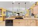Bright kitchen featuring granite countertops, stainless steel appliances, and bar seating at 490 Pine Lily Way, Venice, FL 34293