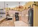 Functional kitchen with granite counters, black appliances, and ample storage at 490 Pine Lily Way, Venice, FL 34293