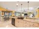 Bright kitchen with granite countertops, stainless appliances, and view to the dining area at 490 Pine Lily Way, Venice, FL 34293