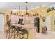 Well-lit kitchen with breakfast bar, granite countertops, and ample cabinet space at 490 Pine Lily Way, Venice, FL 34293