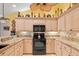 Bright kitchen features granite countertops, tile backsplash, and painted cabinetry at 490 Pine Lily Way, Venice, FL 34293