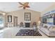 Spacious living room showcasing a fireplace, tiled flooring and neutral decor at 490 Pine Lily Way, Venice, FL 34293