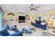 Bright living room with ceiling fan, built-ins, and comfortable seating at 490 Pine Lily Way, Venice, FL 34293
