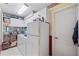 Pantry featuring white refrigerator, cabinets and stocked shelves at 490 Pine Lily Way, Venice, FL 34293