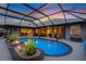 Enclosed pool area features lush landscaping and direct access to the interior living areas at 490 Pine Lily Way, Venice, FL 34293
