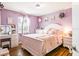 Cozy bedroom featuring hardwood floors, soft lavender walls, and elegant decor at 4922 18Th E St, Bradenton, FL 34203