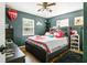 View of a cozy bedroom with a ceiling fan, natural light and quirky decorations at 4922 18Th E St, Bradenton, FL 34203