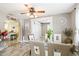 Bright dining room with wood-look tile flooring and a glass-top table with seating for six at 4922 18Th E St, Bradenton, FL 34203
