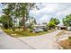 Wide driveway with ample parking space and a view of the house and surrounding greenery at 4922 18Th E St, Bradenton, FL 34203