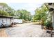 Wide driveway with a trailer, truck, utility vehicles and a backyard with large trees at 4922 18Th E St, Bradenton, FL 34203