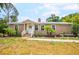 Charming home featuring a well-manicured lawn, cozy front porch, and colorful landscaping at 4922 18Th E St, Bradenton, FL 34203