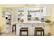 Spacious kitchen featuring white cabinets, granite countertops, an island with seating, and stainless appliances at 4922 18Th E St, Bradenton, FL 34203