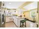 Open kitchen featuring white cabinets, granite countertops, an island with seating, and stainless appliances at 4922 18Th E St, Bradenton, FL 34203