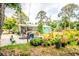 View of the backyard with plants, a patio, seating, and exterior view of home at 4922 18Th E St, Bradenton, FL 34203