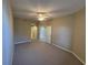 Spacious bedroom with neutral carpet, ceiling fan, and access to ensuite bathroom at 5330 Hyland Hills Ave # 2314, Sarasota, FL 34241
