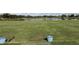Scenic driving range overlooking a serene lake, perfect for golf enthusiasts to practice at 5330 Hyland Hills Ave # 2314, Sarasota, FL 34241