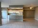 Open concept kitchen featuring white cabinets, tile flooring, and modern appliances at 5330 Hyland Hills Ave # 2314, Sarasota, FL 34241