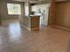Open floor plan with kitchen island, white appliances, and tile flooring throughout at 5330 Hyland Hills Ave # 2314, Sarasota, FL 34241