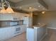 Modern kitchen with white cabinetry, granite countertops, and open layout to living area at 5330 Hyland Hills Ave # 2314, Sarasota, FL 34241