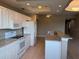 Bright kitchen featuring white cabinetry, modern appliances, and granite countertops at 5330 Hyland Hills Ave # 2314, Sarasota, FL 34241