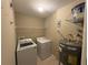 Laundry room featuring washer, dryer, and shelving at 5330 Hyland Hills Ave # 2314, Sarasota, FL 34241