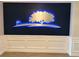 A stunning lighted tree and golf flag logo accents the elegant dark blue wall above wainscoting in the entry lobby at 5330 Hyland Hills Ave # 2314, Sarasota, FL 34241