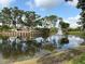 Community pond with fountain and landscaped entryway at 5330 Hyland Hills Ave # 2314, Sarasota, FL 34241