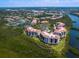 An aerial shot of the condo community, highlighting its proximity to waterways and surrounding landscape at 5430 Eagles Point Cir # 101, Sarasota, FL 34231