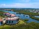 An aerial view of the condo complex, showcasing its waterfront location and surrounding greenery at 5430 Eagles Point Cir # 101, Sarasota, FL 34231