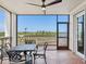 Outdoor balcony featuring dining table with seating and screened enclosure for comfort at 5430 Eagles Point Cir # 101, Sarasota, FL 34231