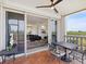Lovely covered balcony features a table and chairs, plus views into the living and dining rooms at 5430 Eagles Point Cir # 101, Sarasota, FL 34231