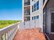 Exterior shot of the outdoor balcony featuring the tile flooring and white railing at 5430 Eagles Point Cir # 101, Sarasota, FL 34231