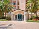 Inviting entrance featuring a covered portico, brick pavers, and well-maintained landscaping at 5430 Eagles Point Cir # 101, Sarasota, FL 34231