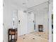 Foyer area with tile flooring, a mirrored wall, and decorative furnishings at 5430 Eagles Point Cir # 101, Sarasota, FL 34231