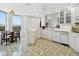 Kitchen featuring white cabinets, decorative backsplash, and adjacent breakfast nook at 5430 Eagles Point Cir # 101, Sarasota, FL 34231