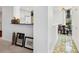 Hallway leads to kitchen and breakfast nook with decorative tile flooring at 5430 Eagles Point Cir # 101, Sarasota, FL 34231
